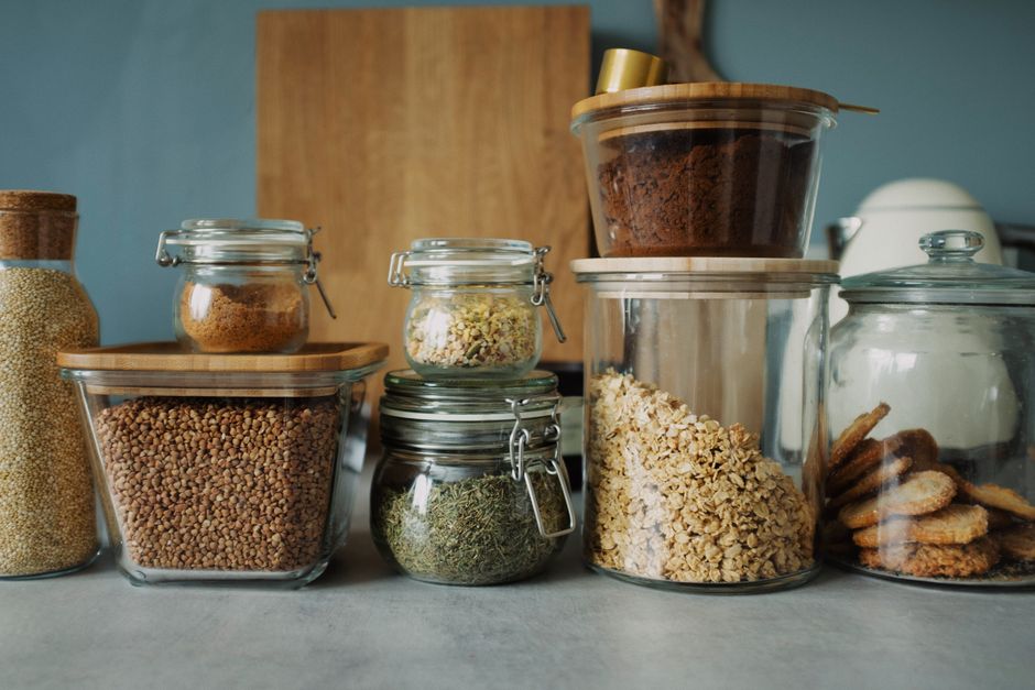 Stylish pantry setup with a variety of foods in glass storage jars, showcasing dry goods a
