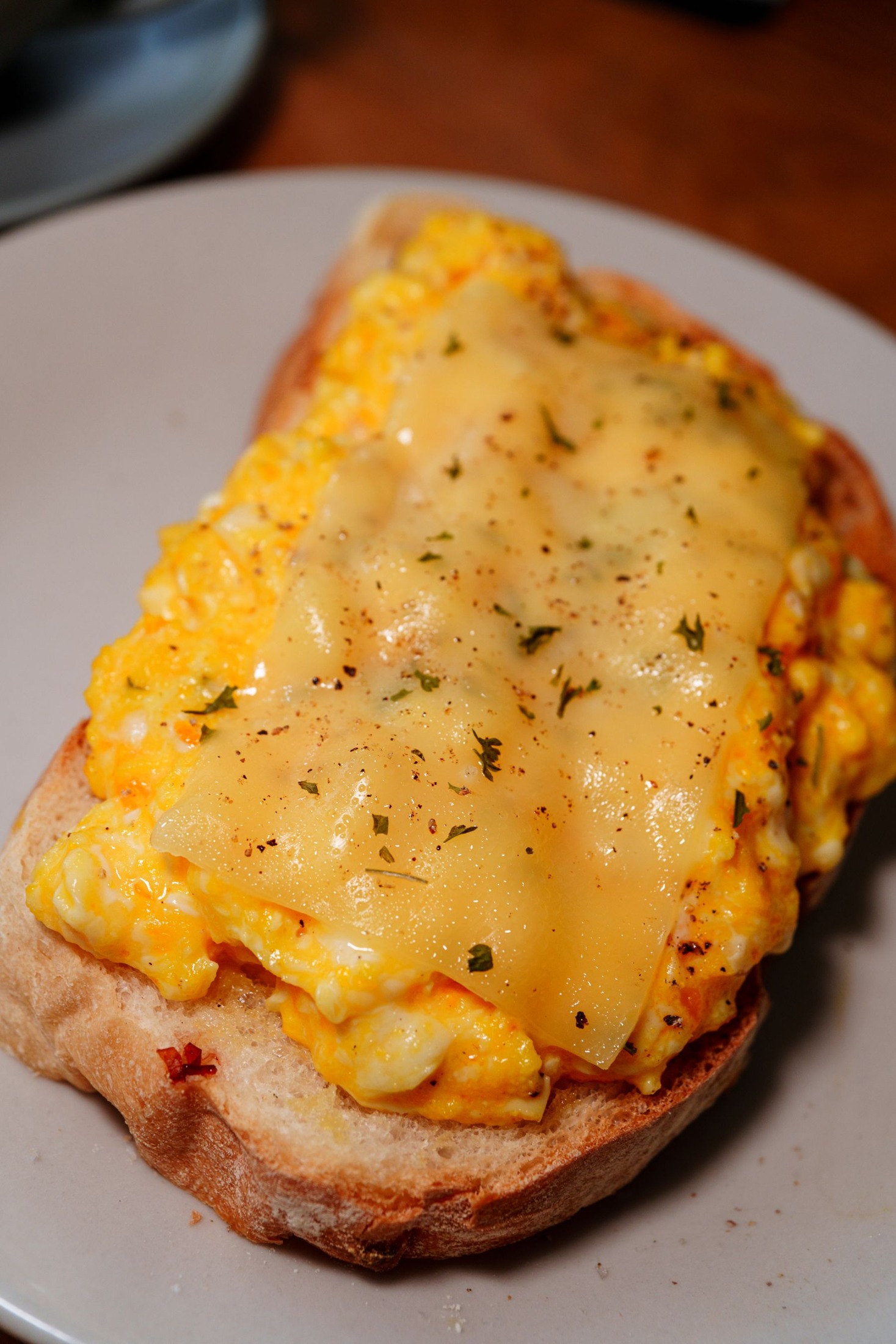 Scrambled egg and melted cheese on toast.