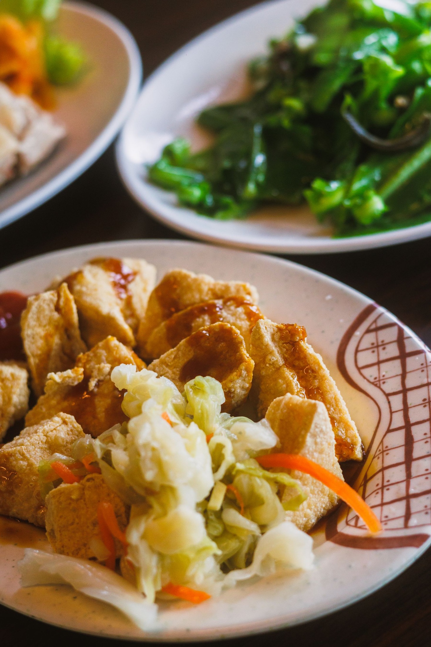 Crispy tofu with fresh vegetables on a plate.